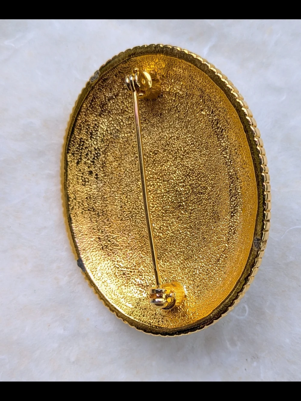 Black and Gold Oval Brooch with Central Pearl Accent